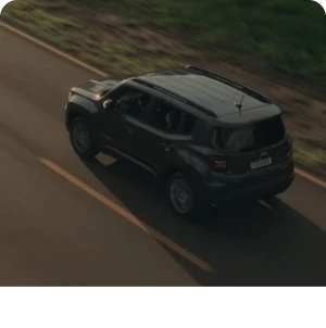 Black SUV driving on a road during the day.